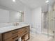 Stylish bathroom with a glass-enclosed shower and a wooden vanity at 800 Collany Rd # 605 & 606, Tierra Verde, FL 33715