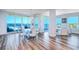 Elegant dining room featuring a modern chandelier and breathtaking ocean views framed by large windows at 800 Collany Rd # 605 & 606, Tierra Verde, FL 33715