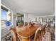 Spacious dining room features an ornate wood table, seating for eight, and a large window with water views at 800 Collany Rd # 605 & 606, Tierra Verde, FL 33715