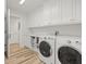 Well-organized laundry room with modern appliances, ample storage and wood floors at 800 Collany Rd # 605 & 606, Tierra Verde, FL 33715
