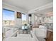 Inviting living room with comfortable seating, a glass table, and scenic views enhancing the open-concept space at 800 Collany Rd # 605 & 606, Tierra Verde, FL 33715