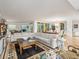 Expansive living room with a large sectional couch, decorative rug, and scenic views from multiple windows at 800 Collany Rd # 605 & 606, Tierra Verde, FL 33715