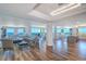 Elegant open-concept living space with wood floors, modern lighting, and panoramic ocean views from the large windows at 800 Collany Rd # 605 & 606, Tierra Verde, FL 33715