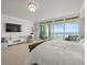 Bright main bedroom features a large bed, ocean views from a private balcony and ample seating areas at 800 Collany Rd # 605 & 606, Tierra Verde, FL 33715