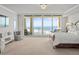 Bright main bedroom features a large bed, ocean views from a private balcony and ample seating areas at 800 Collany Rd # 605 & 606, Tierra Verde, FL 33715