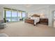 Bright main bedroom features a large bed, ocean views, and a sitting area with a picturesque seaside outlook at 800 Collany Rd # 605 & 606, Tierra Verde, FL 33715