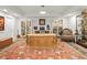 Large office with a large carved wood desk, display cases and seating area at 800 Collany Rd # 605 & 606, Tierra Verde, FL 33715