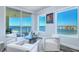 Comfortable sitting room with stylish white furniture, ocean views, and access to a private balcony at 800 Collany Rd # 605 & 606, Tierra Verde, FL 33715