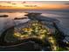 Luxury waterfront community at sunset, featuring upscale buildings, landscaping, and private boat slips at 800 Collany Rd # 605 & 606, Tierra Verde, FL 33715
