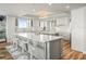 Modern kitchen features a large island with seating, white cabinetry, and high-end appliances at 800 Collany Rd # 605 & 606, Tierra Verde, FL 33715