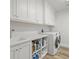 Bright laundry room with white cabinets and new washer/dryer at 800 Collany Rd # 605 & 606, Tierra Verde, FL 33715