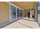 Screened patio with tile flooring and sliding glass doors at 8002 Marbella Creek Ave, Tampa, FL 33625