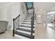 Elegant staircase with dark wood and metal railings at 8002 Marbella Creek Ave, Tampa, FL 33625