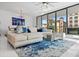 Spacious living area featuring a sectional sofa and large windows offering city views at 100 1St N Ave # 201, St Petersburg, FL 33701