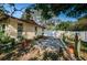 Charming side yard with gravel driveway and potted plants at 1609 Lakeview Rd, Clearwater, FL 33756