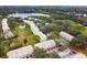 Aerial view of townhouses near a lake, with ample parking and green areas at 2345 Lake Woodberry Cir, Brandon, FL 33510