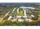 Wide aerial view of community, showing townhouses, lake, and surrounding landscape at 2345 Lake Woodberry Cir, Brandon, FL 33510