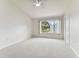 Spacious bedroom with window, ceiling fan, and carpet at 2345 Lake Woodberry Cir, Brandon, FL 33510