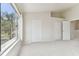 Bright bedroom with large windows and view of lush greenery at 2345 Lake Woodberry Cir, Brandon, FL 33510