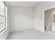 Bright, carpeted bedroom with a large window and an adjoining bathroom for added convenience at 2345 Lake Woodberry Cir, Brandon, FL 33510