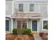 Charming townhouse exterior featuring a welcoming blue front door with decorative wreath and covered porch at 2345 Lake Woodberry Cir, Brandon, FL 33510