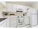 White kitchen with ample counter space and cabinets at 2345 Lake Woodberry Cir, Brandon, FL 33510