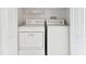 White washer and dryer in a well-lit closet with wire shelving at 2345 Lake Woodberry Cir, Brandon, FL 33510