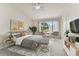 Stylishly decorated bedroom with ample natural light, featuring a comfortable sitting area and modern accents at 2345 Lake Woodberry Cir, Brandon, FL 33510