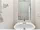 Small half bathroom with a white pedestal sink and mirror at 2345 Lake Woodberry Cir, Brandon, FL 33510