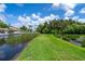 Lush green backyard extending to the waterfront, offering a serene and private outdoor space at 2595 Cyprus Dr # 4-202, Palm Harbor, FL 34684