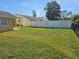 Spacious backyard with a grassy area and fence at 3141 Ludlow Dr, New Port Richey, FL 34655