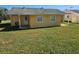 Rear view of a single-story house with backyard at 3141 Ludlow Dr, New Port Richey, FL 34655