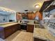 Kitchen boasts wood cabinets, granite countertops, and stainless steel appliances at 3141 Ludlow Dr, New Port Richey, FL 34655