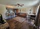 Open concept living room with a kitchen view, wood floors, and a ceiling fan at 3141 Ludlow Dr, New Port Richey, FL 34655
