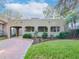 Spanish style home with landscaped yard and brick driveway at 3512 W Granada St, Tampa, FL 33629