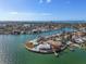 Wide aerial showcasing a waterfront home on a private island with multiple pools at 485 41St Ave, St Pete Beach, FL 33706