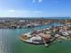 An aerial view showcasing a luxurious waterfront home with multiple pools at 485 41St Ave, St Pete Beach, FL 33706