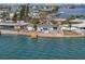 Aerial view of a waterfront home with a spacious backyard and private dock at 485 41St Ave, St Pete Beach, FL 33706