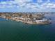 Bird's-eye view of a charming waterfront home nestled amongst lush greenery at 485 41St Ave, St Pete Beach, FL 33706