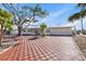 Charming single-story home with a brick driveway and large tree at 485 41St Ave, St Pete Beach, FL 33706