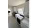 Laundry room with modern washer and dryer, white cabinets, and sleek black wine cooler at 485 41St Ave, St Pete Beach, FL 33706