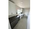 Functional laundry room with modern appliances, ample white cabinetry, and sleek black wine cooler at 485 41St Ave, St Pete Beach, FL 33706