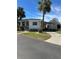 Front view of a white manufactured home with a carport and landscaping at 4851 W Gandy Blvd # B1L30, Tampa, FL 33611