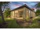 Screened-in patio area at dusk with surrounding landscaping at 5641 Sunset Falls Dr, Apollo Beach, FL 33572