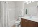 Clean bathroom with white tile, shower/tub combo, and wood vanity at 5641 Sunset Falls Dr, Apollo Beach, FL 33572
