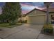 Home exterior with attached two-car garage and lush landscaping at 5641 Sunset Falls Dr, Apollo Beach, FL 33572