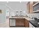 A view of the kitchen highlighting the granite countertops and the open layout into the dining area at 5641 Sunset Falls Dr, Apollo Beach, FL 33572
