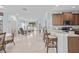 Open kitchen with breakfast bar, dining area, and living room at 5641 Sunset Falls Dr, Apollo Beach, FL 33572