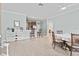 Open-concept kitchen and dining area with white piano at 5641 Sunset Falls Dr, Apollo Beach, FL 33572