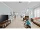 Spacious living room with a piano, comfortable seating, and views of the dining area at 5641 Sunset Falls Dr, Apollo Beach, FL 33572